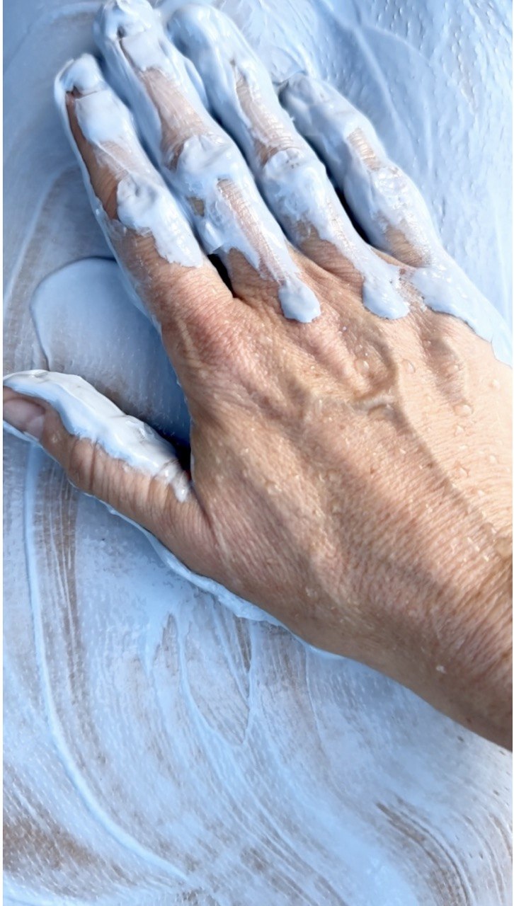 A nourishing body cream being prepared for a wellness ritual