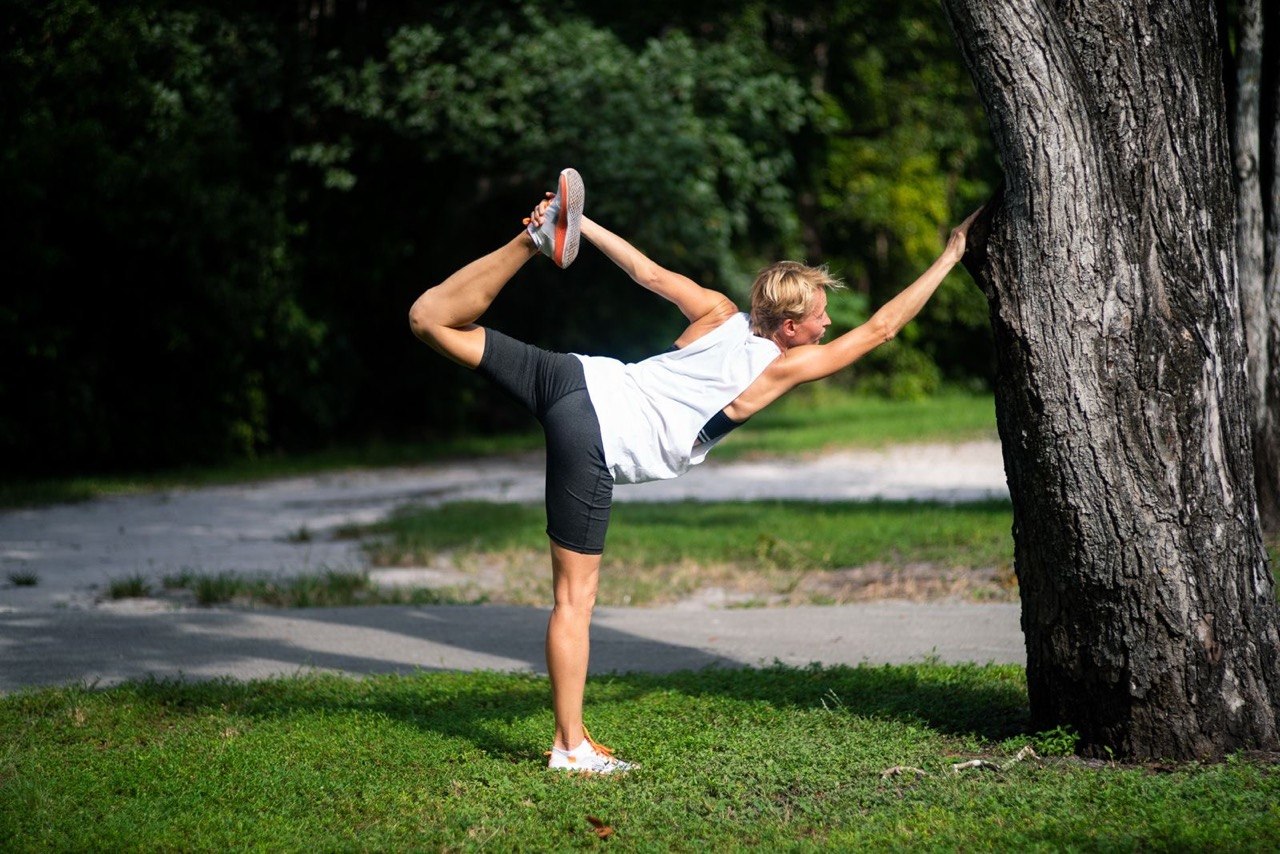 Natalia practicing a standing yoga pose outdoors